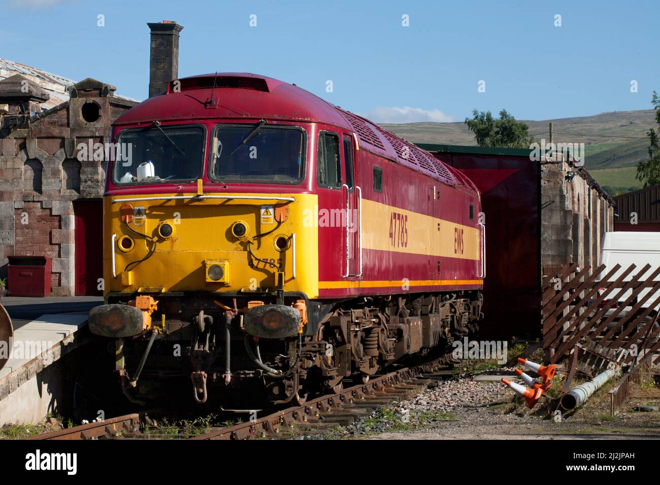 Class 47 locomotive 47785 at Kirkby Stephen East (Stainmore railway) wearing full EWS livery Stock Photo