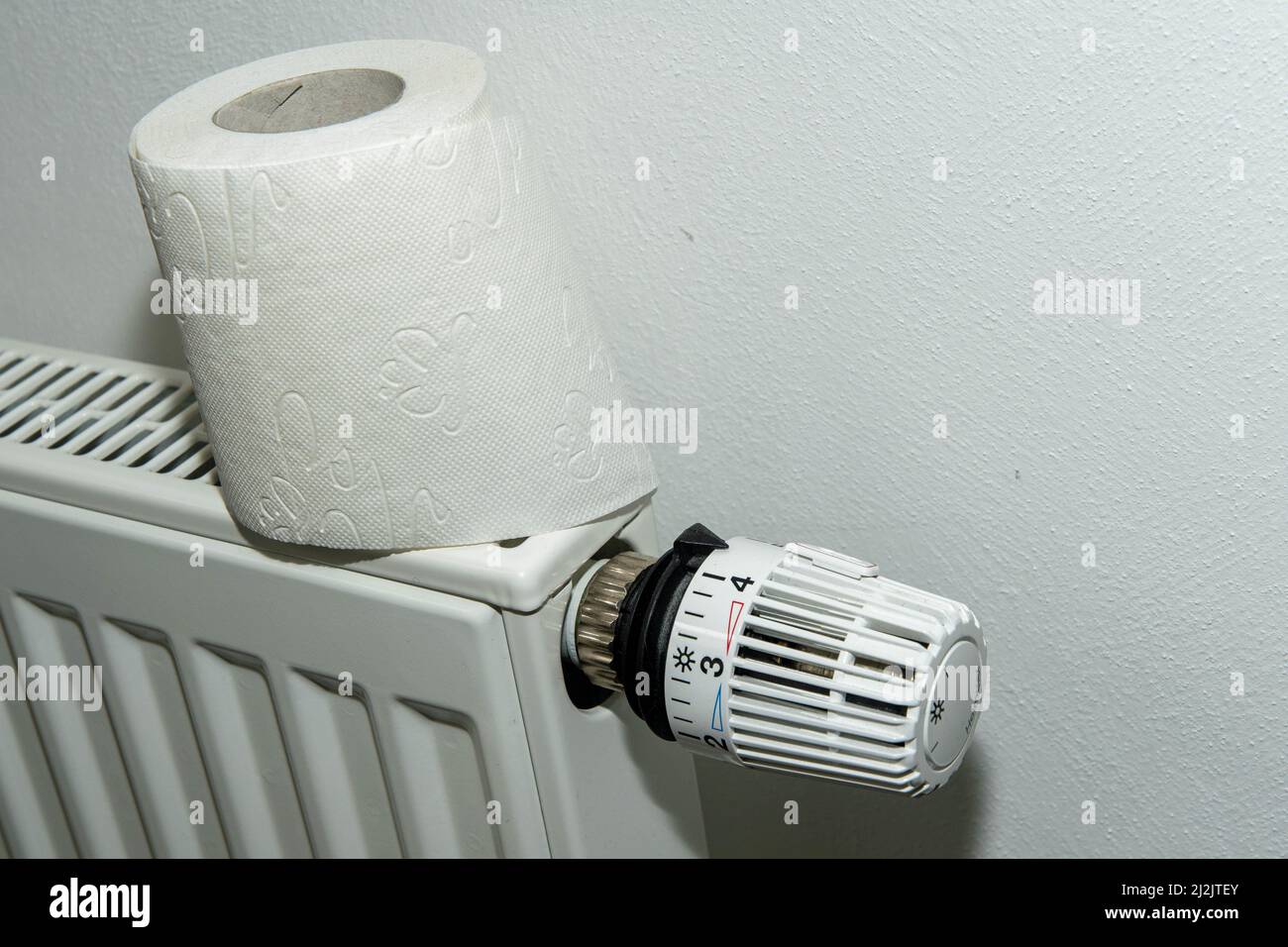 Toilet paper on turned up radiator Stock Photo - Alamy