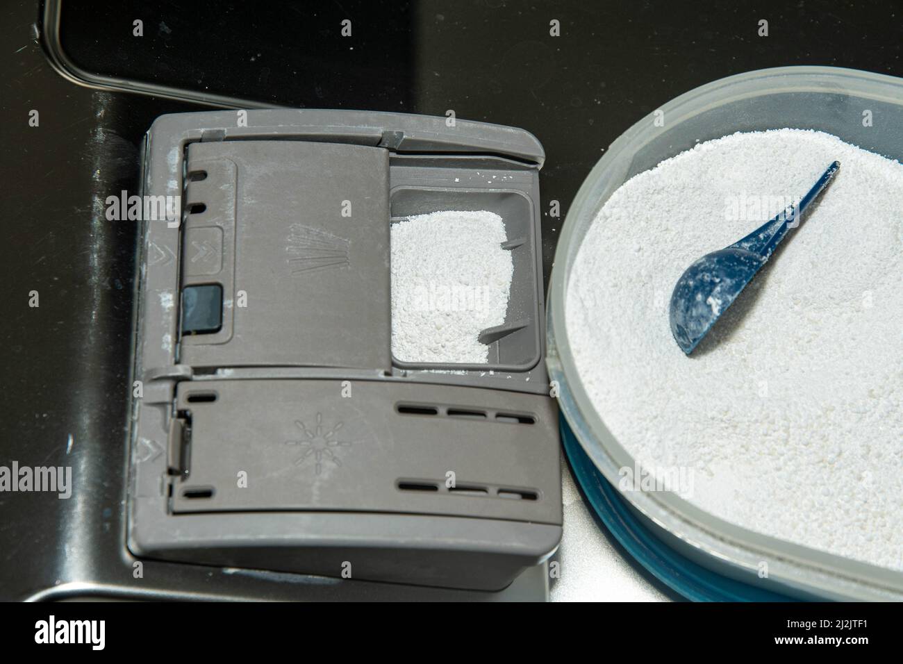 Fill dishwasher with cleaning powder Stock Photo Alamy