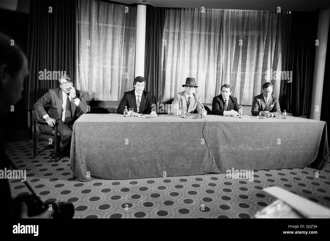 Left to right, Frank Pressland (Lawyer), Paul White (From Hanover Drew), Elton John, John Reid (Elton's manager) and Eddie Plumley (MD of Watford). Pictured during a press statement about Elton John's £2 Million sale of Watford FC. 8th December 1987. Stock Photo