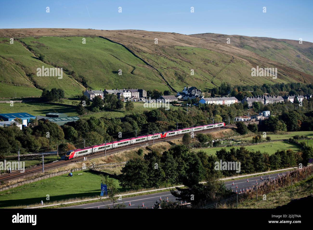 2 Virgin trains Bombardier class 221 voyager trains passing the countryside at Tebay on the west coast mainline Stock Photo