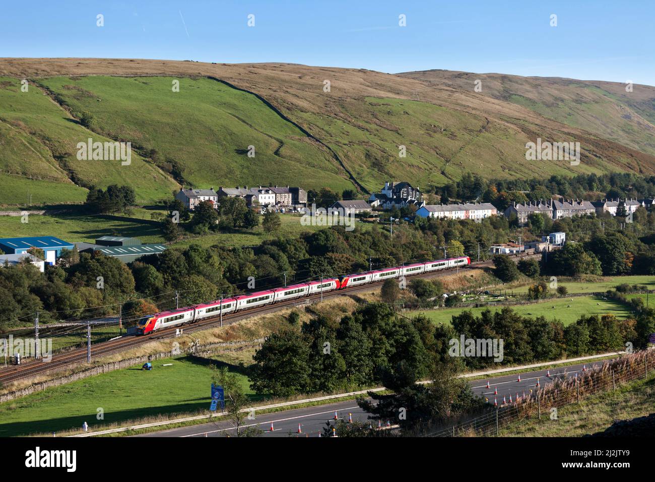 2 Virgin trains Bombardier class 221 voyager trains passing the countryside at Tebay on the west coast mainline Stock Photo