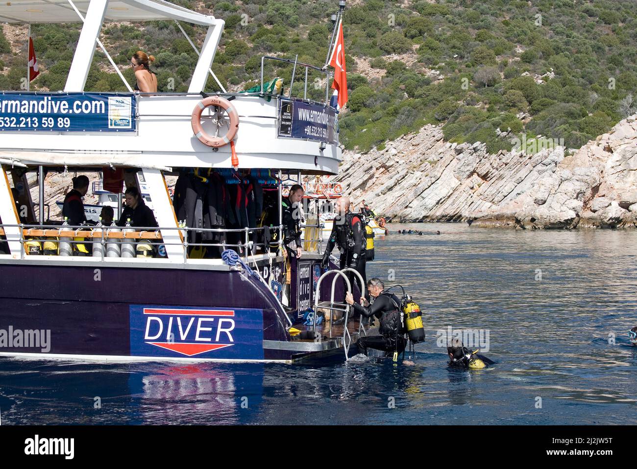 Scuba diver at the ledder of the dive boat Emandive, Bodrum, Turkey, Mediterranean Sea Stock Photo