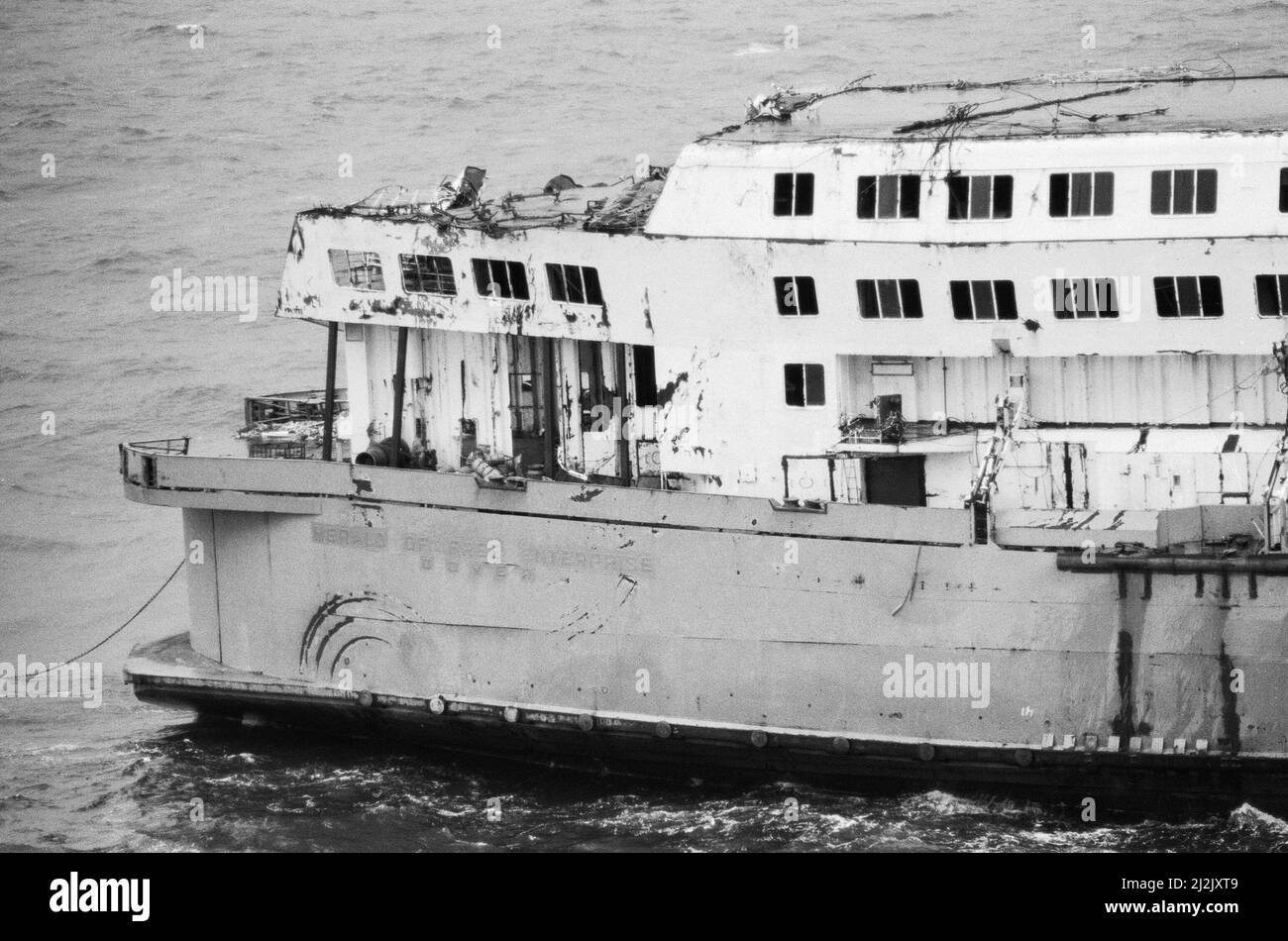 The wreckage of the Herald of Free Enterprise, which capsized at Zeebrugge in March 1987, being towed along the English Channel on her final voyage towards a breakers yard in the port city of Izmir in Turkey  where she will be scrapped. The ship, renamed Flushing Range, was towed by the tug Markus Turm. 6th October 1987. Stock Photo