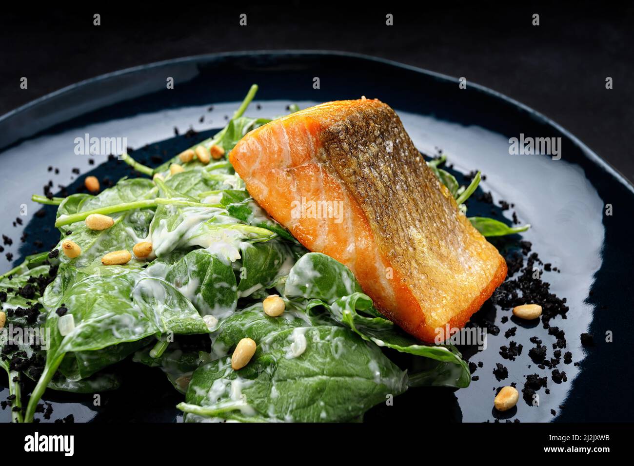Grilled salmon fillet with herbs, on a dark background Stock Photo - Alamy