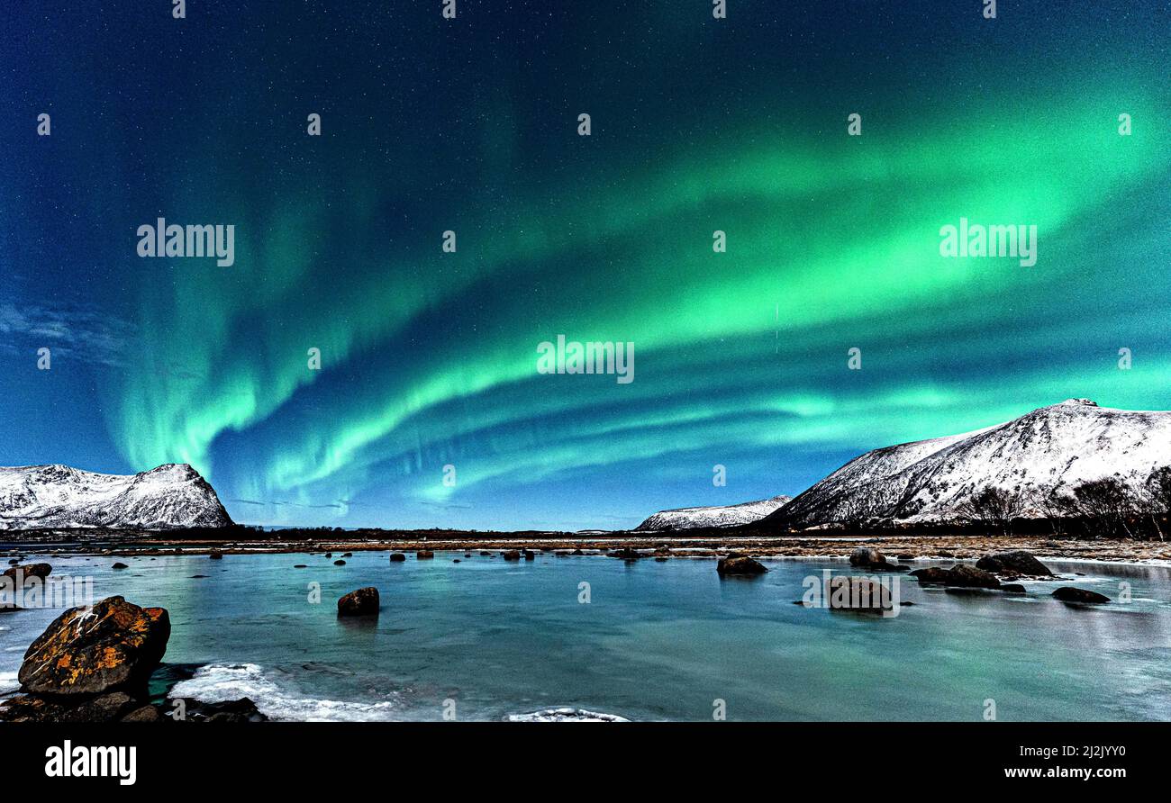 Northern lights over coastal winter landscape, Risoyhamn, Andoya ...