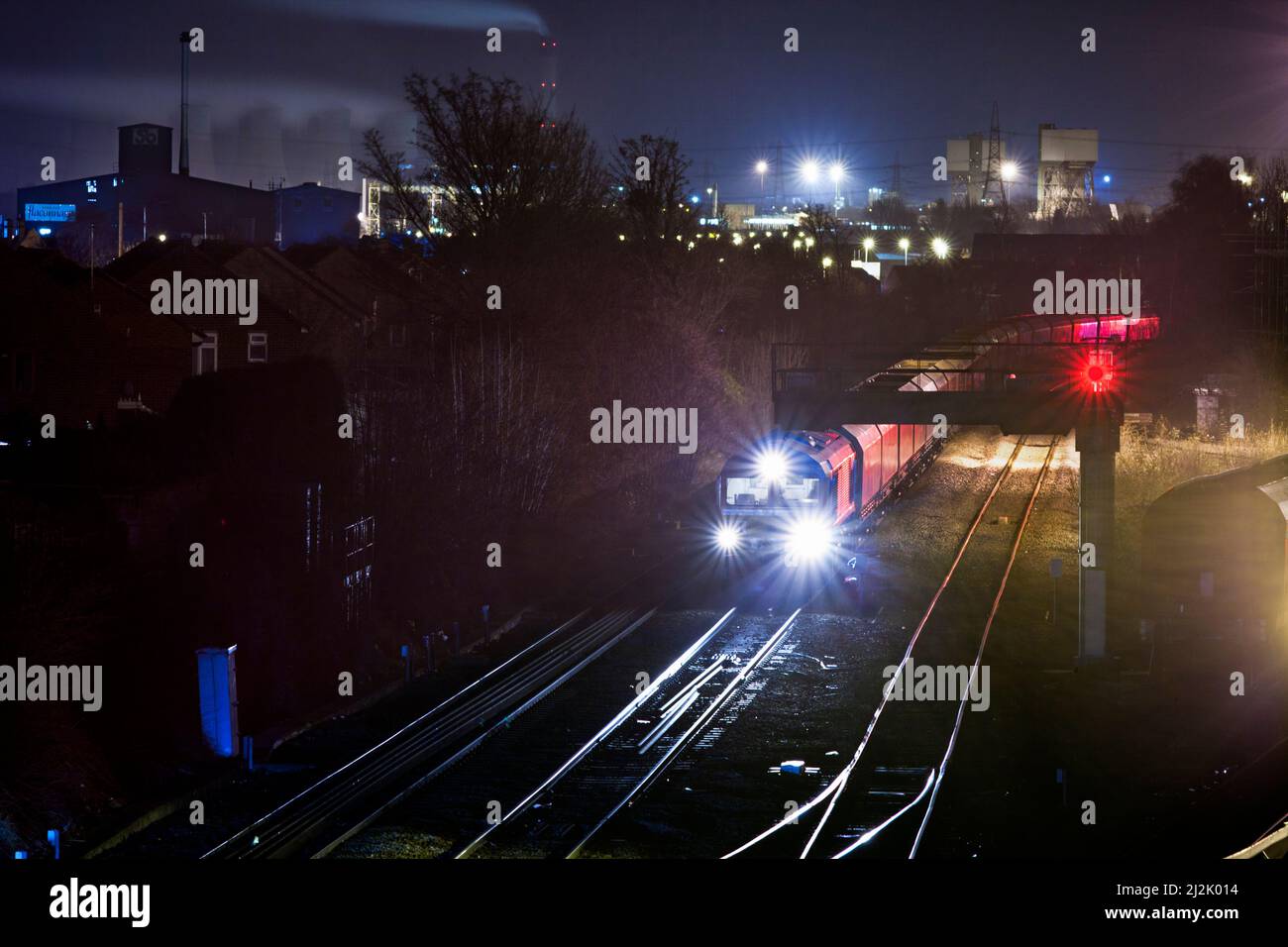 DB Schenker class 66 locomotive at Knottingley at night with Eggborough power station and Kellingley colliery behind Stock Photo