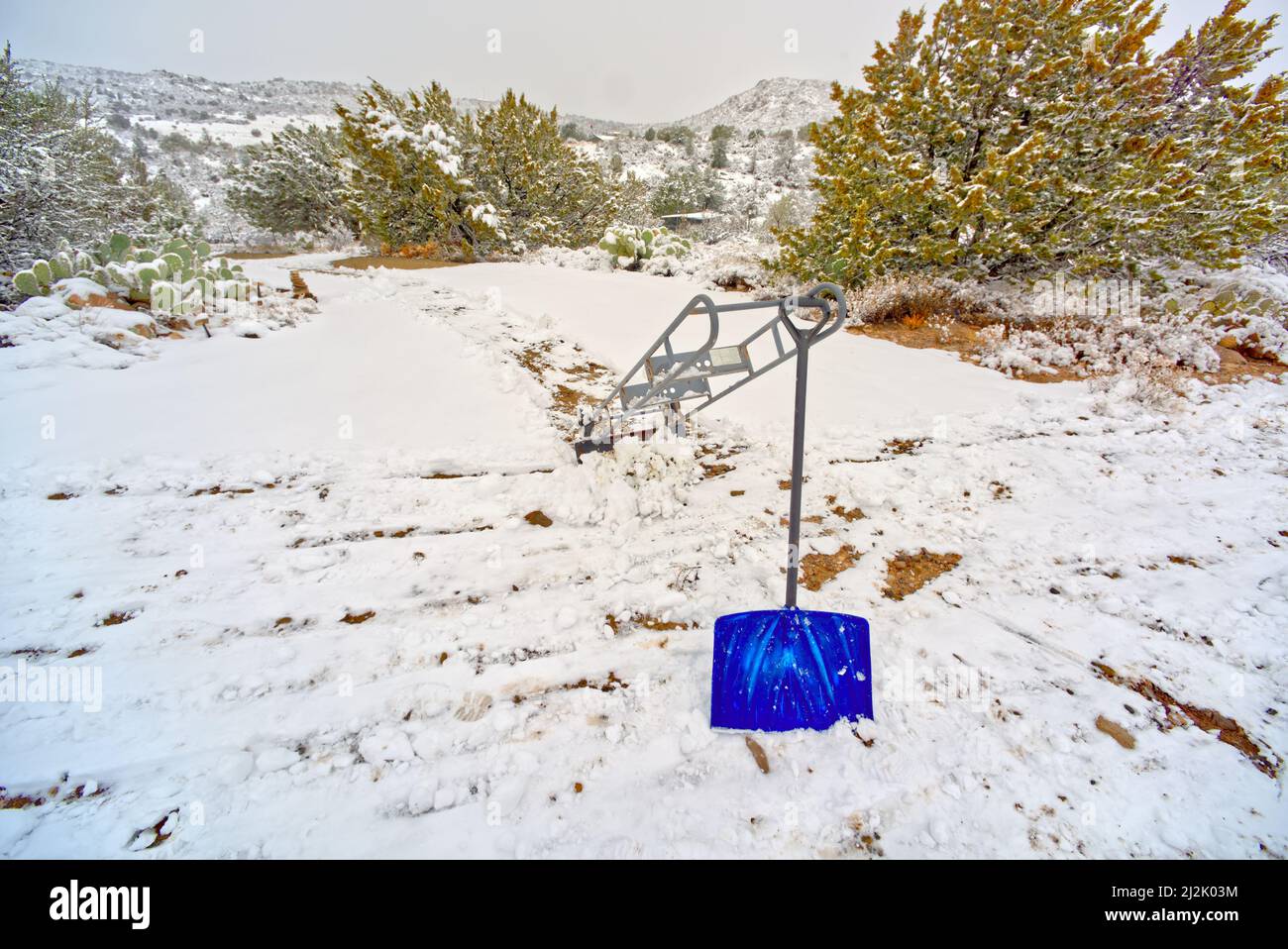 Appliance dolly and shovel in the snow, Chino Valley, Arizona, USA Stock Photo