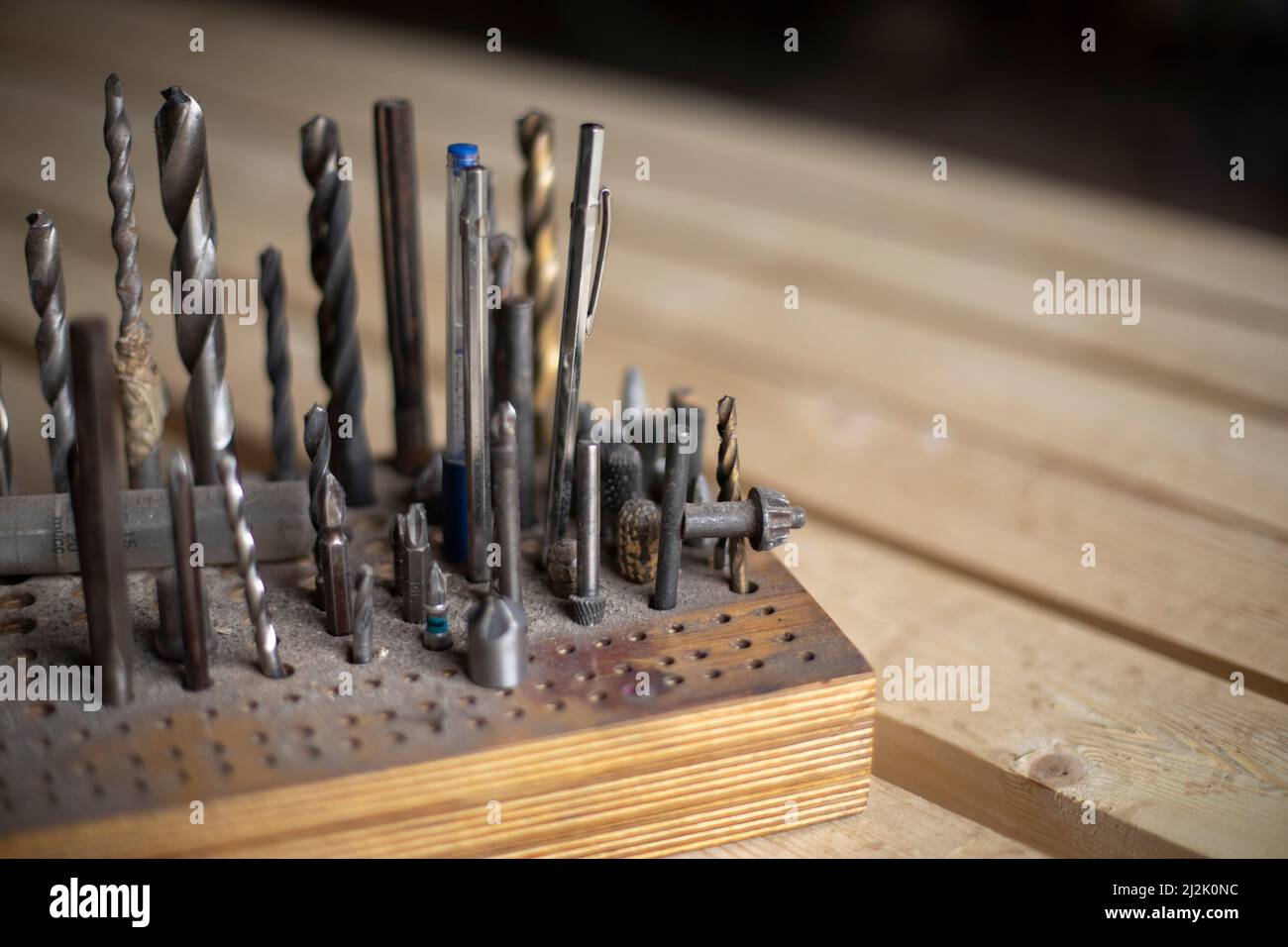 Drill bits for drills. Tools in garage. Drill bits in box. Production