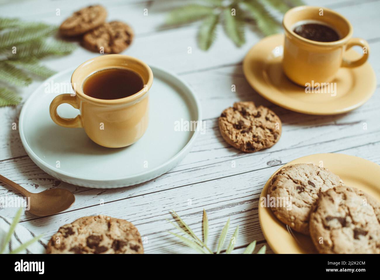 Two cups of black coffee and chocolate chip cookies on a table Stock Photo  - Alamy