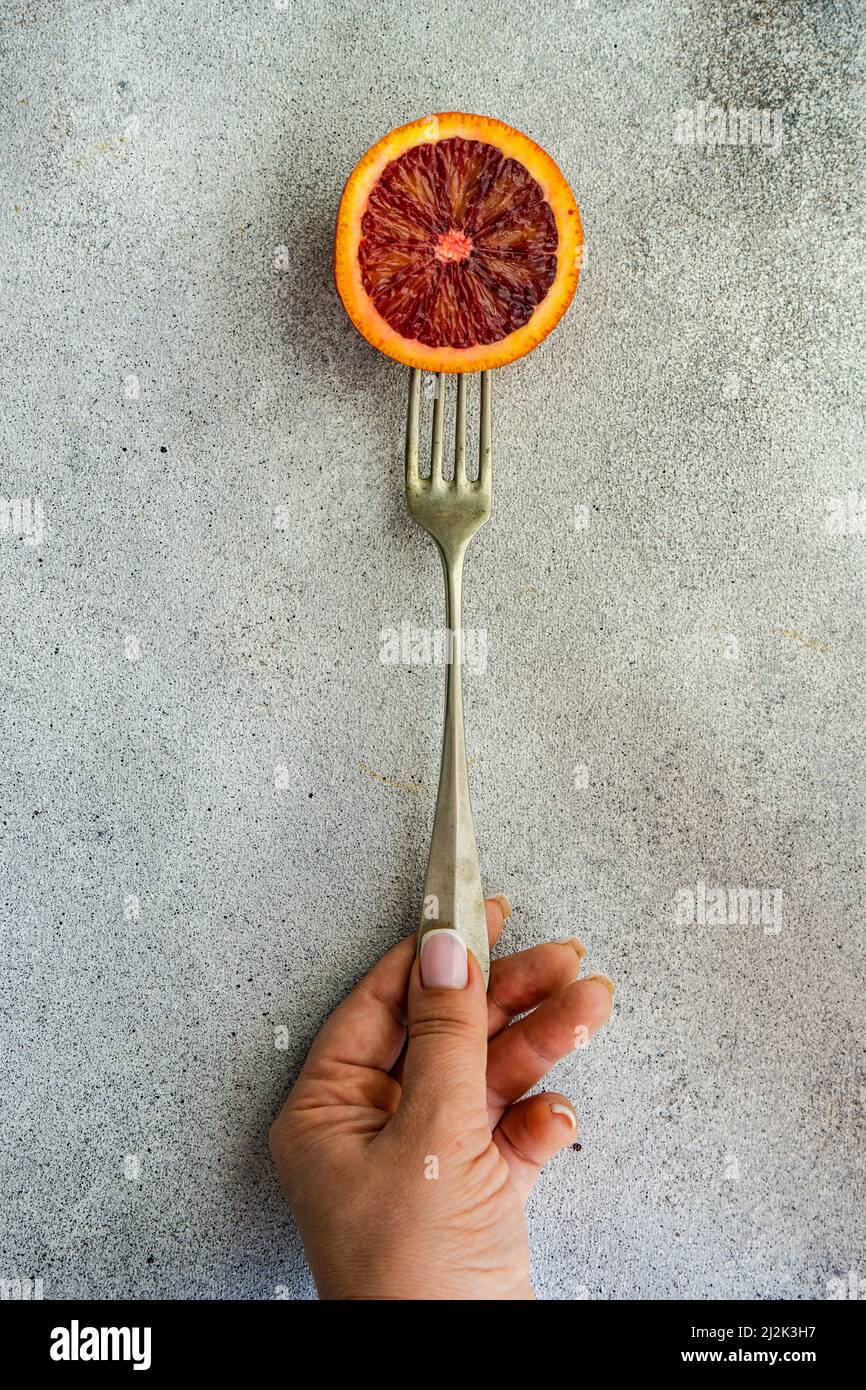 Hand holding half orange hi-res stock photography and images - Alamy