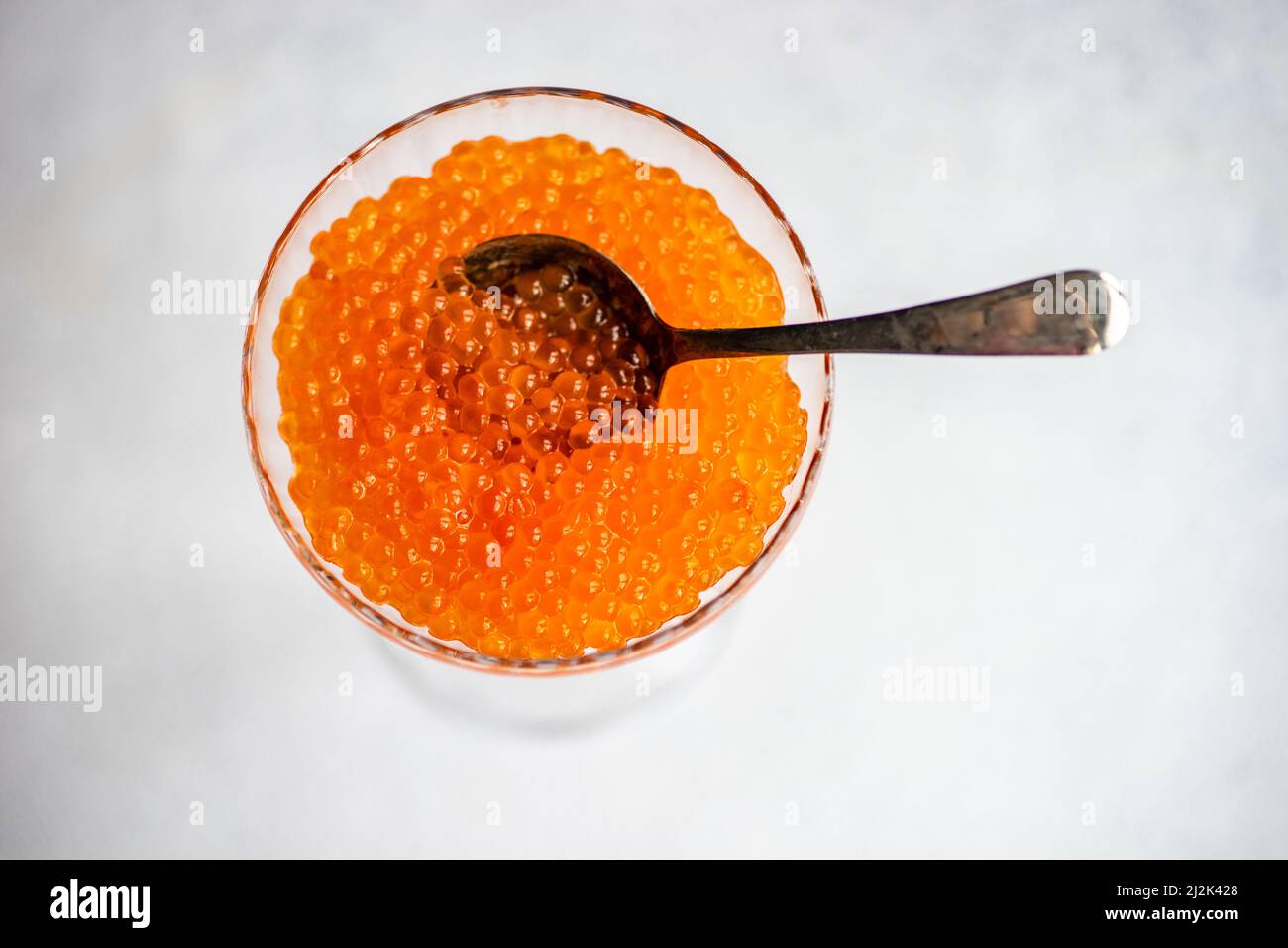 Overhead view of red trout caviar served in a glass dessert coupe Stock ...