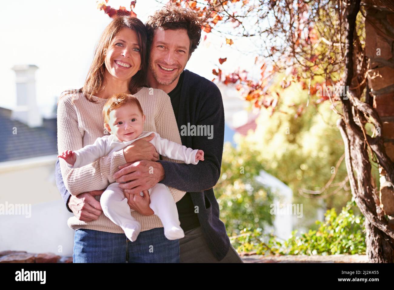 Their little bundle of joy. A portrait of a happy couple holding their baby outdoors. Stock Photo