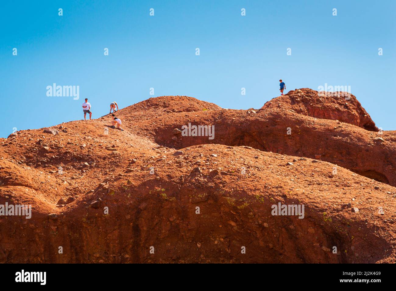 People climbing the rocks around Papago Park Hole in the Rock in Phoenix, Arizona, United States Stock Photo