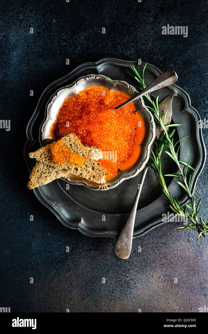Overhead view of red trout caviar with toast Stock Photo - Alamy