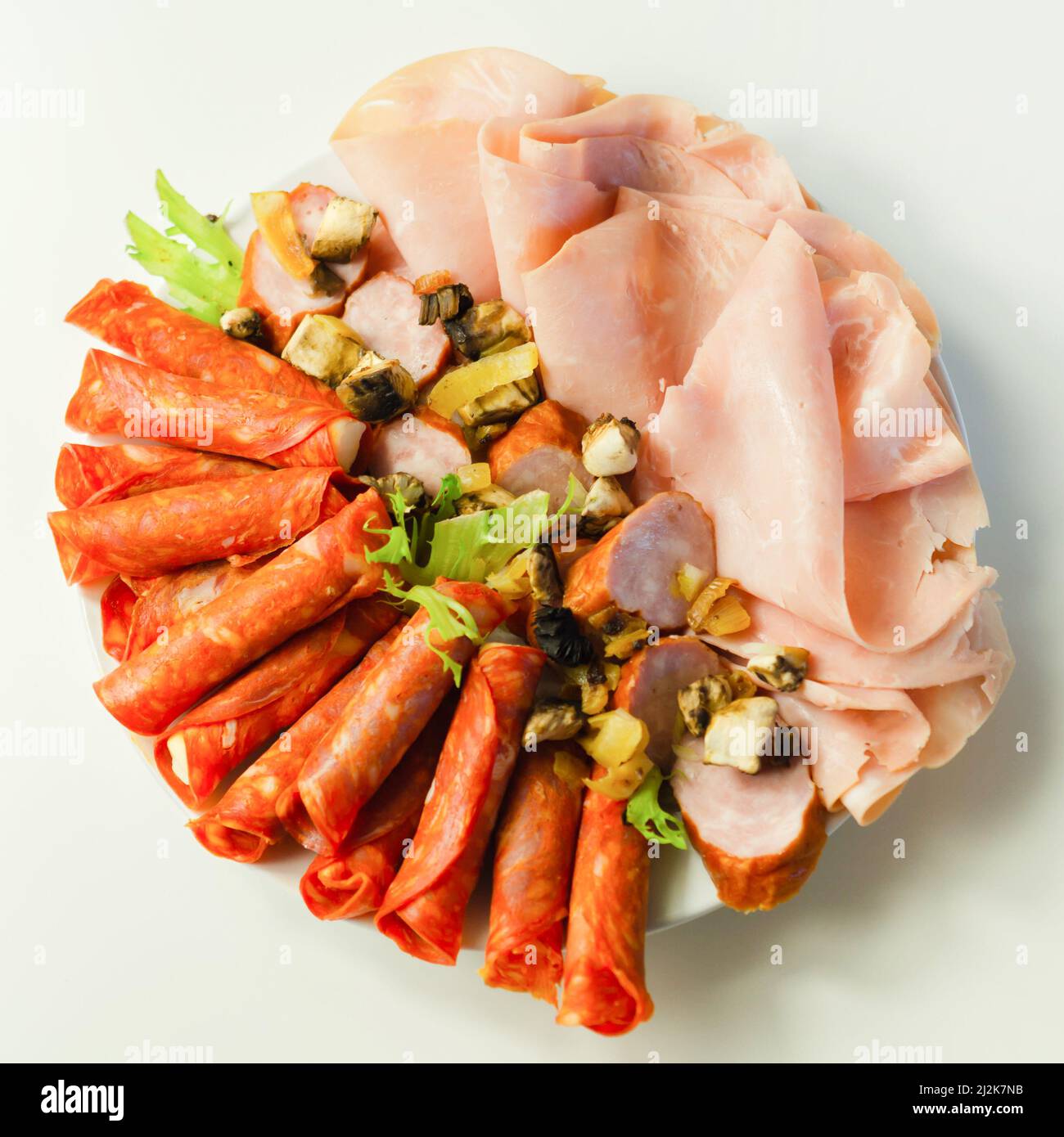 A cold plate prepared for the party with sliced chorizo, ham and