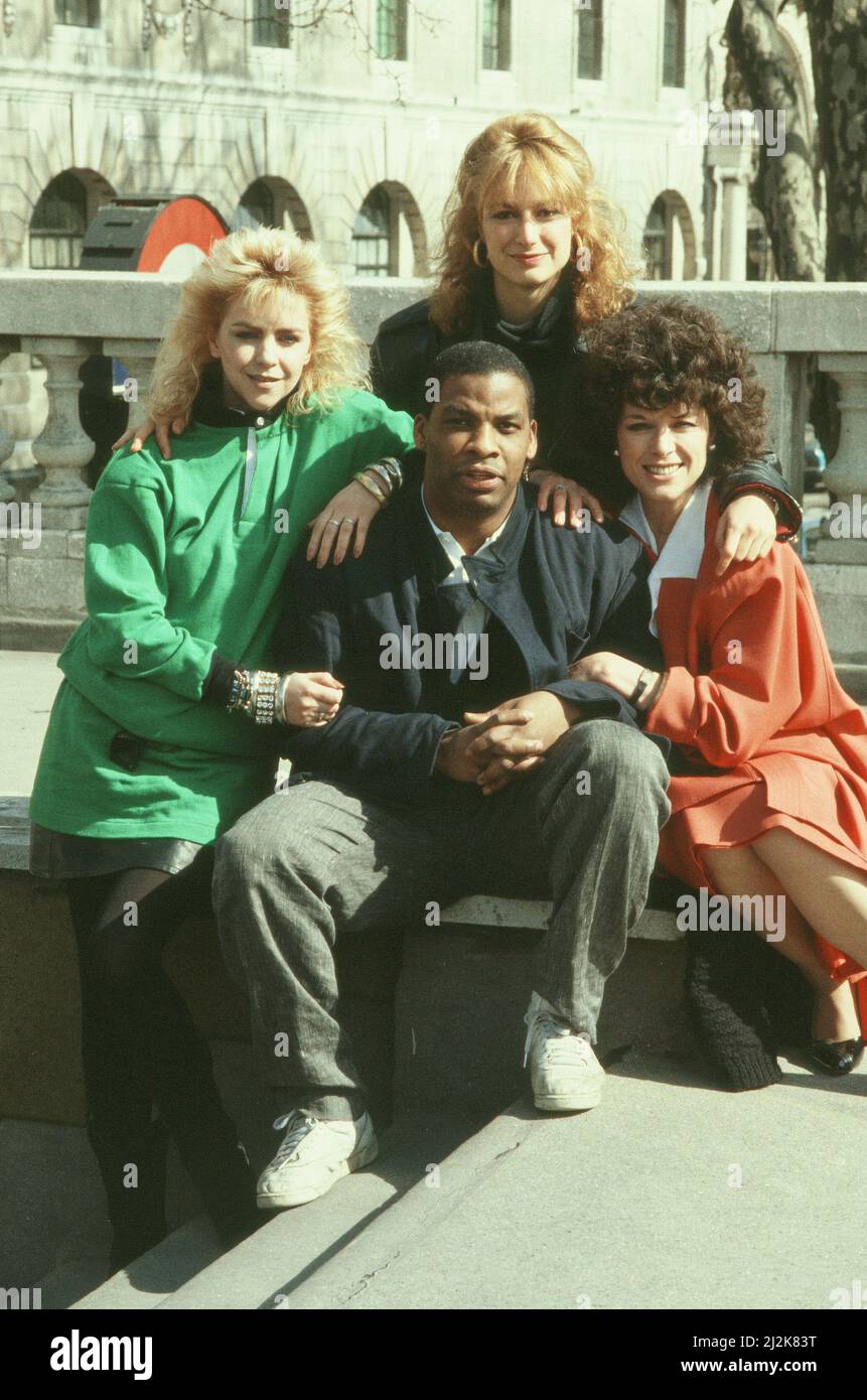 The cast of CATS Eyes.  TV Detective series. C.A.T.S. Eyes was a British television series made by TVS for ITV between 1985 and 1987. The series was a spin-off from The Gentle Touch, and saw Jill Gascoine reprise her role as Maggie Forbes, having left the police force to join an all-female private detective agency called 'Eyes', based in Kent, that is actually a front for a Home Office team called C.A.T.S. (Covert Activities Thames Section).  Picture shows . Leslie Ash (in green) , Jill Gascoine (in orange) ,  Tracy Louise Ward (in black) and Don Warrington. (sitting at the centre)  Picture ta Stock Photo