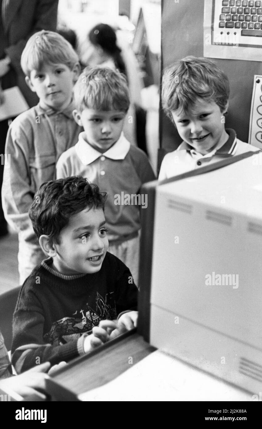 When ICI Wilton presented a BBC Micro Computer to Abingdon Road Infants School, Middlesbrough, the children didn't take long too enjoy working and playing on it and pictured leading some of his school mates on the keys is five-year-old Amer Qayyum. 21st March 1988. Stock Photo