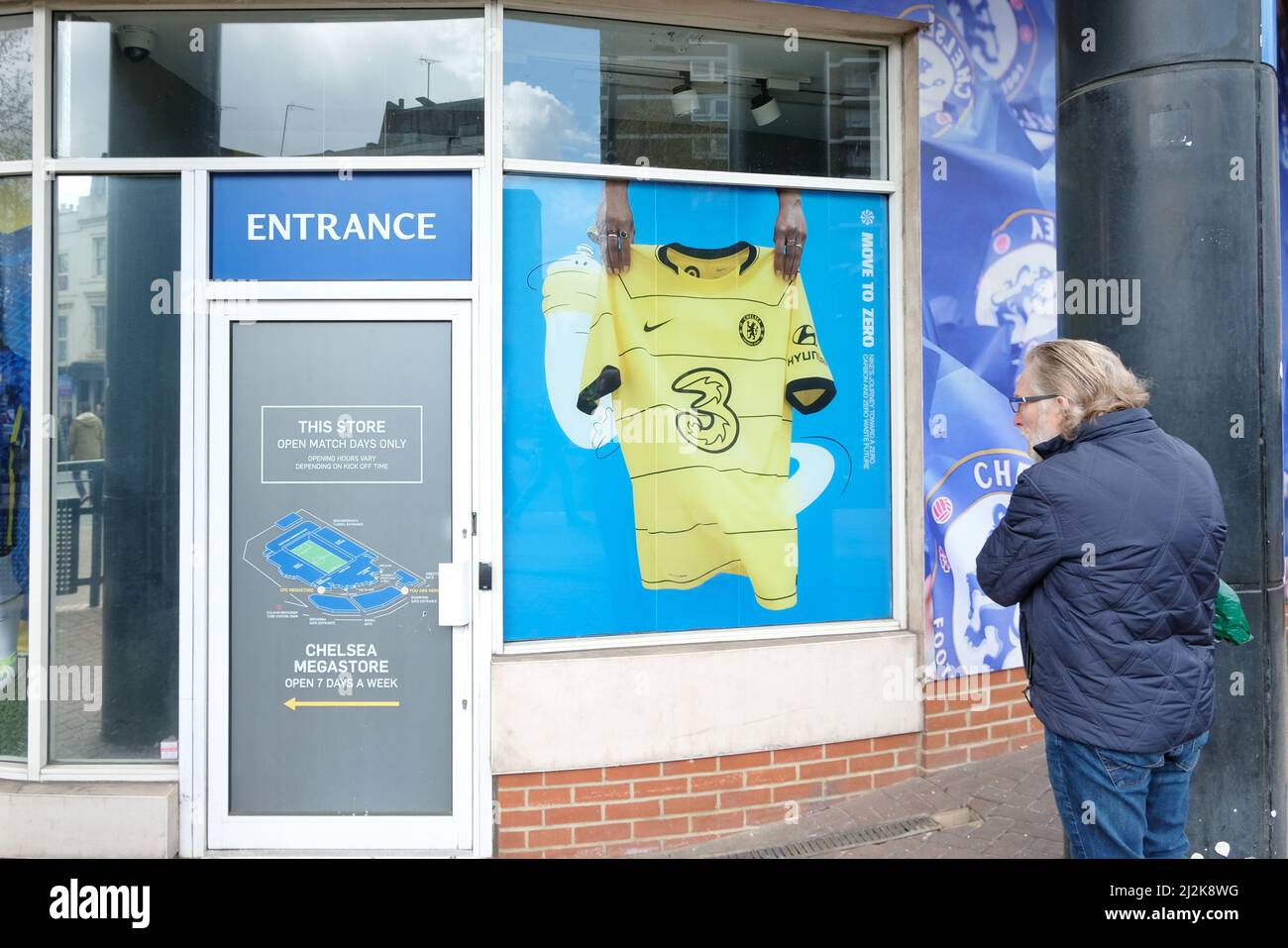 London, UK, 2nd April, 2022. A man stands outside the Chelsea football club shop which has been closed for several weeks after owner Roman Abramovich was removed as the club's owner, ticket sales halted and merchandise sales were banned. Credit: Eleventh Hour Photography/Alamy Live News Stock Photo