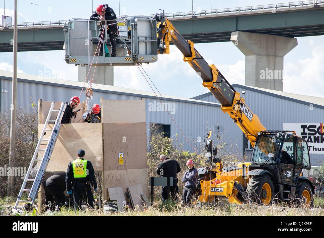 Greys, Thurrock, UK 2 April 2022 Just Stop Oil protesters block roads at Thurrock oil depot. Four protesters climbed aboard an oil tanker securing themselves on the roof with lock-ons while another group created a wooden structure that covered a tunnel dug under the road. One man was removed from the top of the wooden structure and arrested. The structure was then removed and the tunnel team began work on removing the tunnellers. Credit: Denise Laura Baker/Alamy Live News Stock Photo