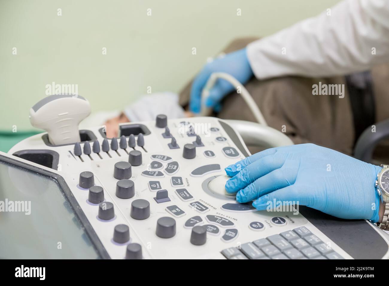 gynecologist doctor prepares an ultrasound machine for the diagnosis of