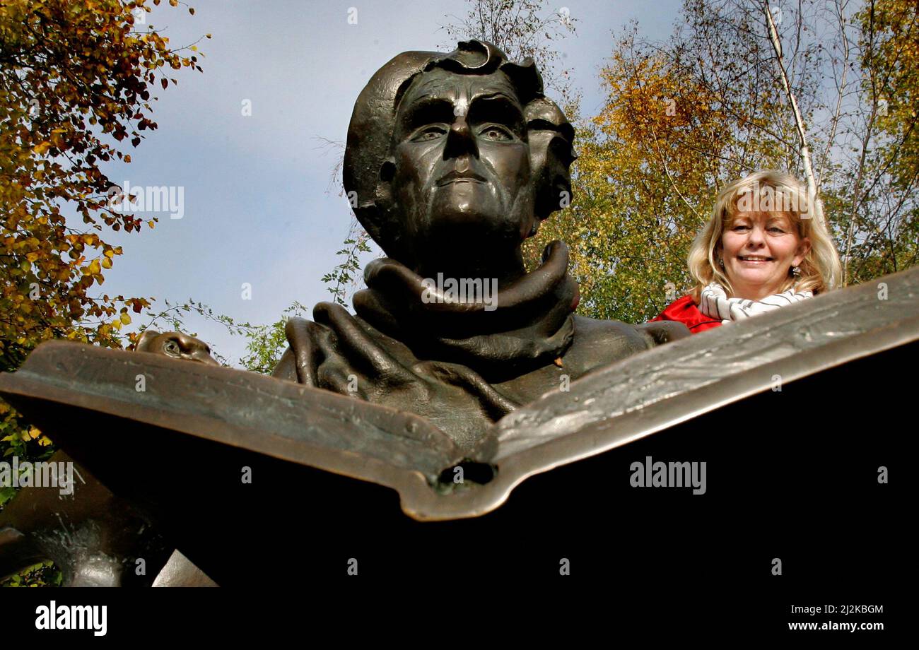 Portrait of the actress Inger Nilsson who played Astrid Lindgren's Pippi. Photographed at Djurgården in Stockholm. To the left the statue of Astrid Lindgren. Stock Photo