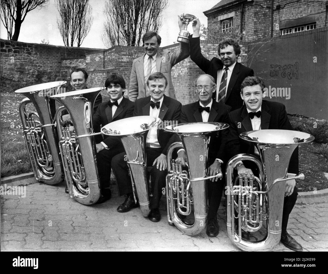 The Felling Brass Band, conductor Ray Poole (left) and Colin Brewis, hold the Northern Area (Fourth Section) trophy above the tuba section, from the left, Brian Harden, Steven Cossey, Terry Evans, Cliff Milburn and Andrew Turnbull. 28th April 1988. Stock Photo