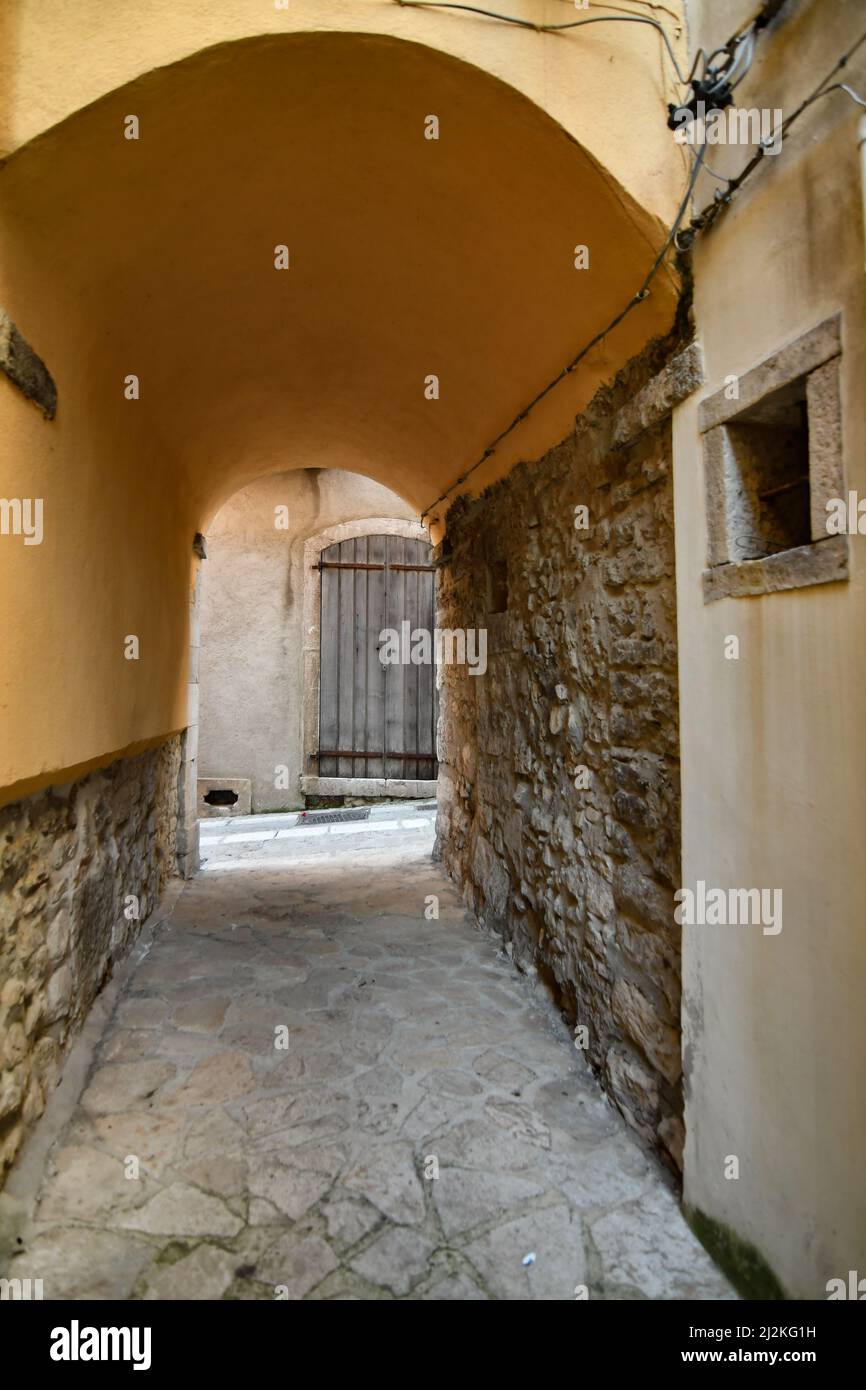 A narrow street among the old stone houses of Taurasi, medieval town in