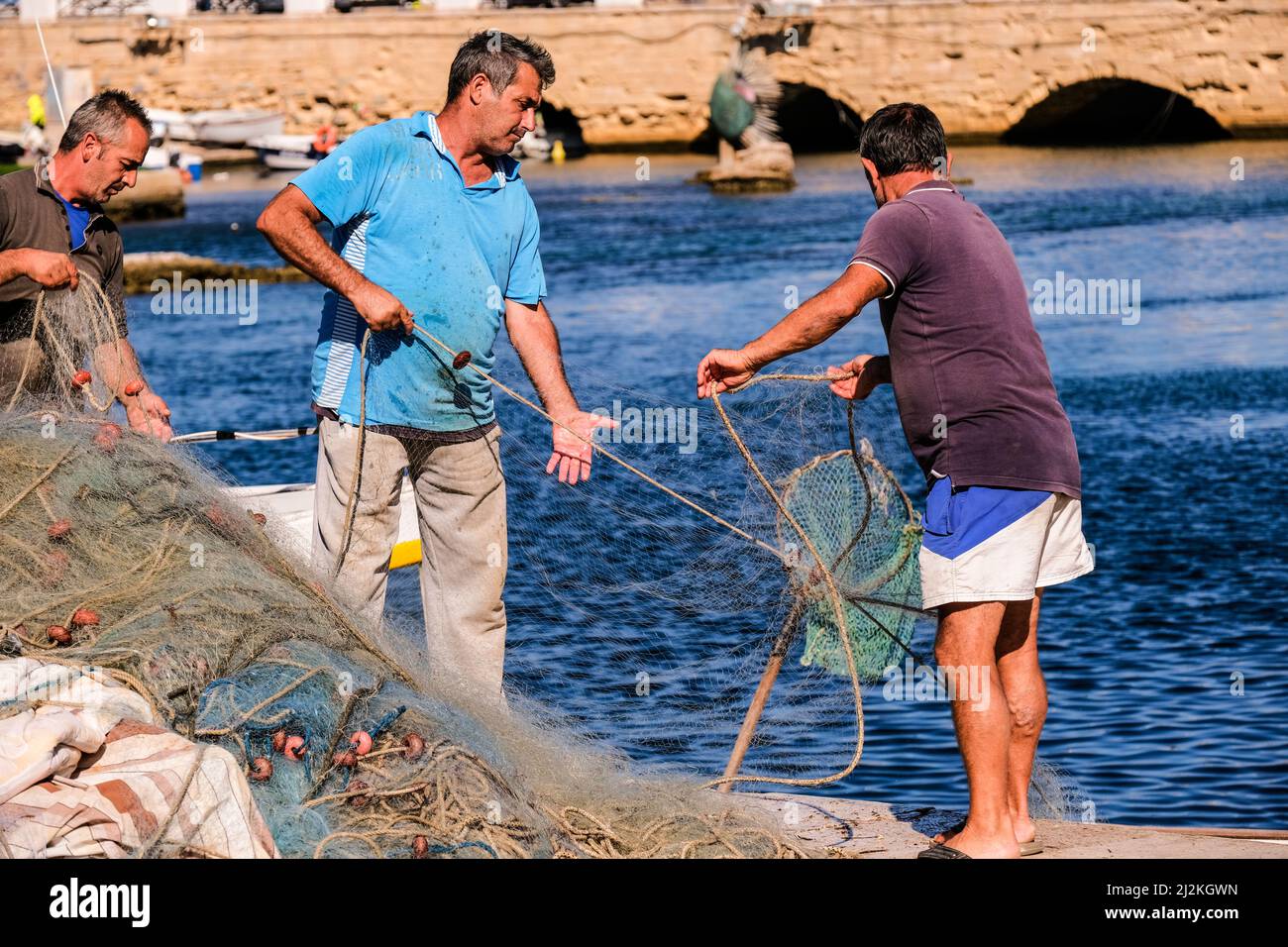 Italy Puglia. Gallipoli. Fishermen control the nets Stock Photo