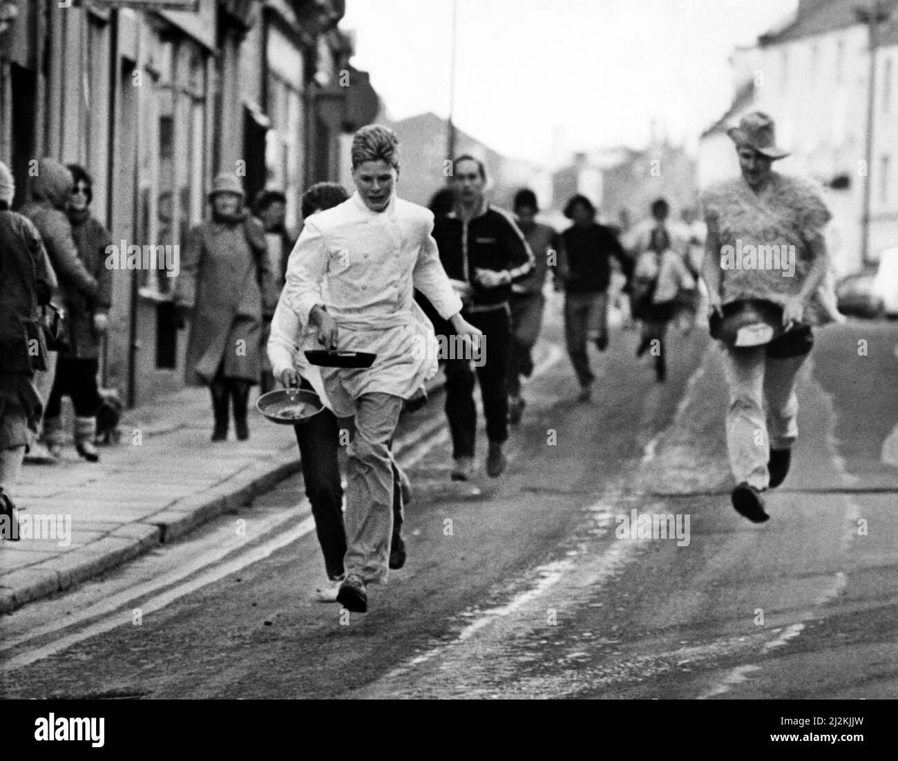 Competitors take part in the Alnwick Shrove Tuesday Pancake race 16