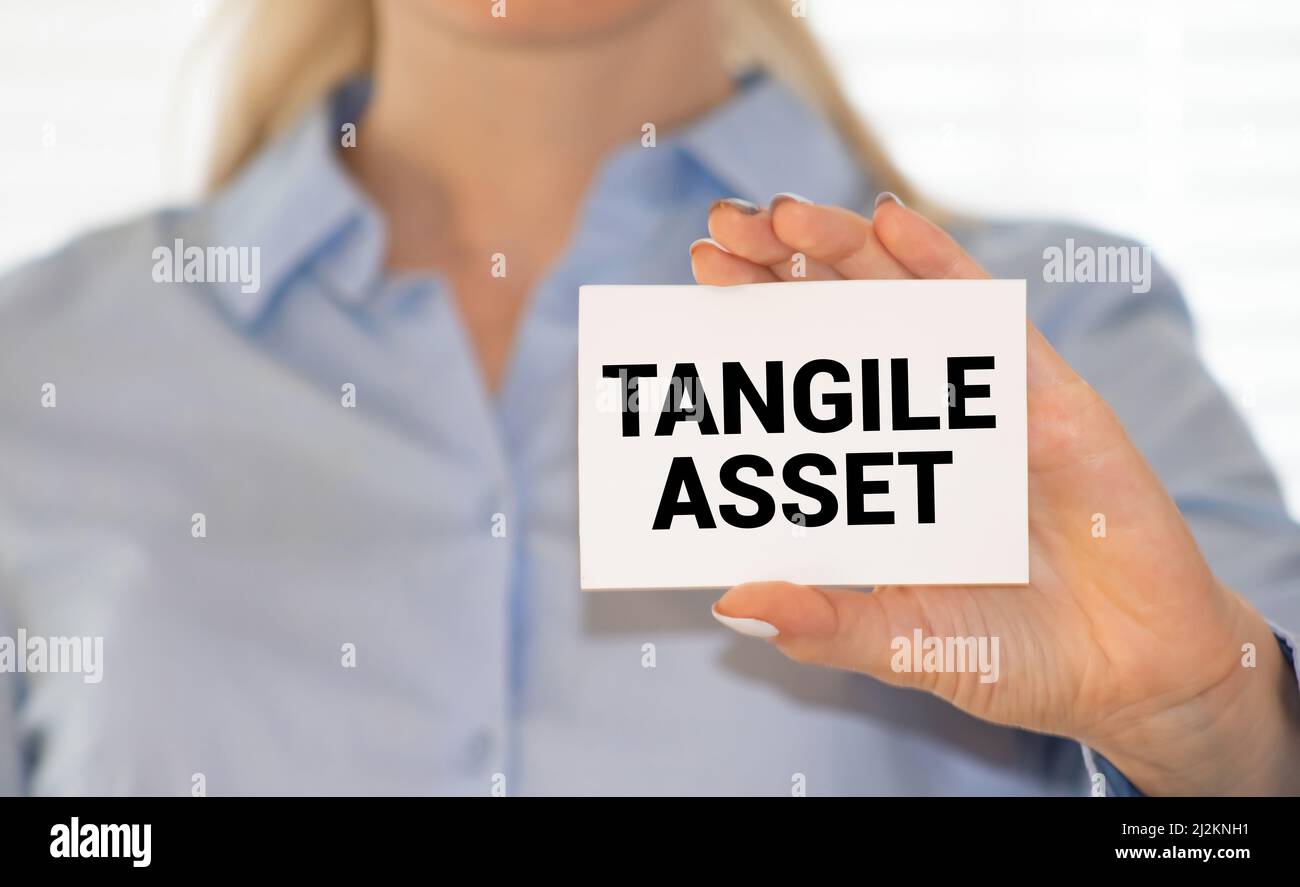 Tangible Asset text written on a notebook with pencils Stock Photo