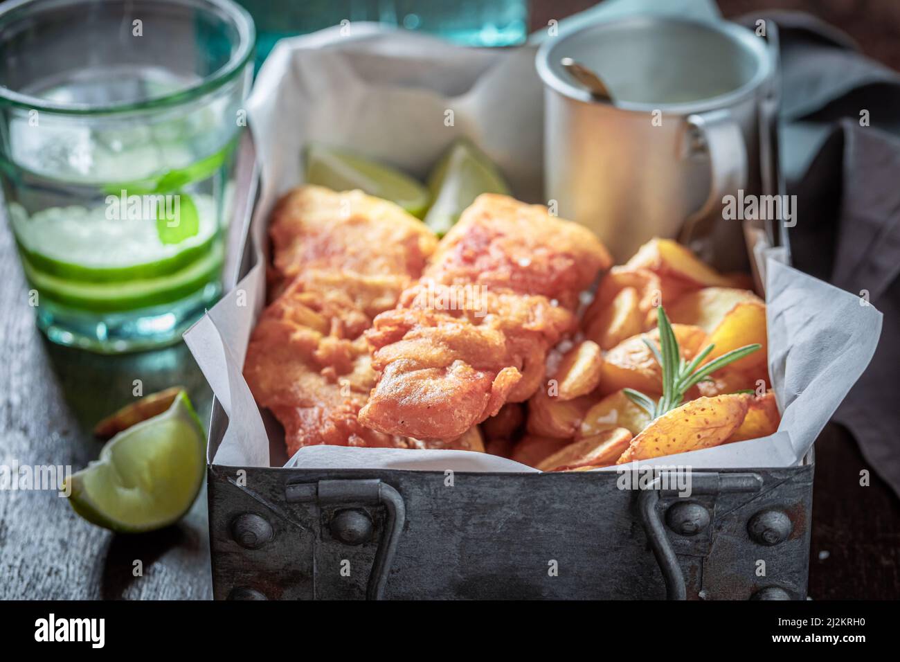 Roasted fish and chips with sauces and lime. Fried cod with fries ...