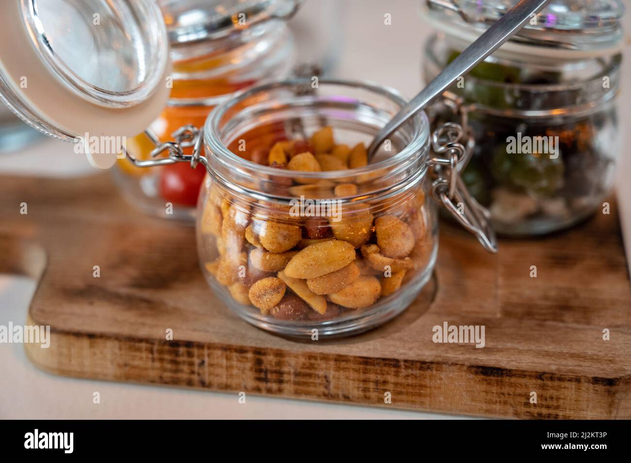 Glass jars with healthy party snacks served in bar, tasty appetisers