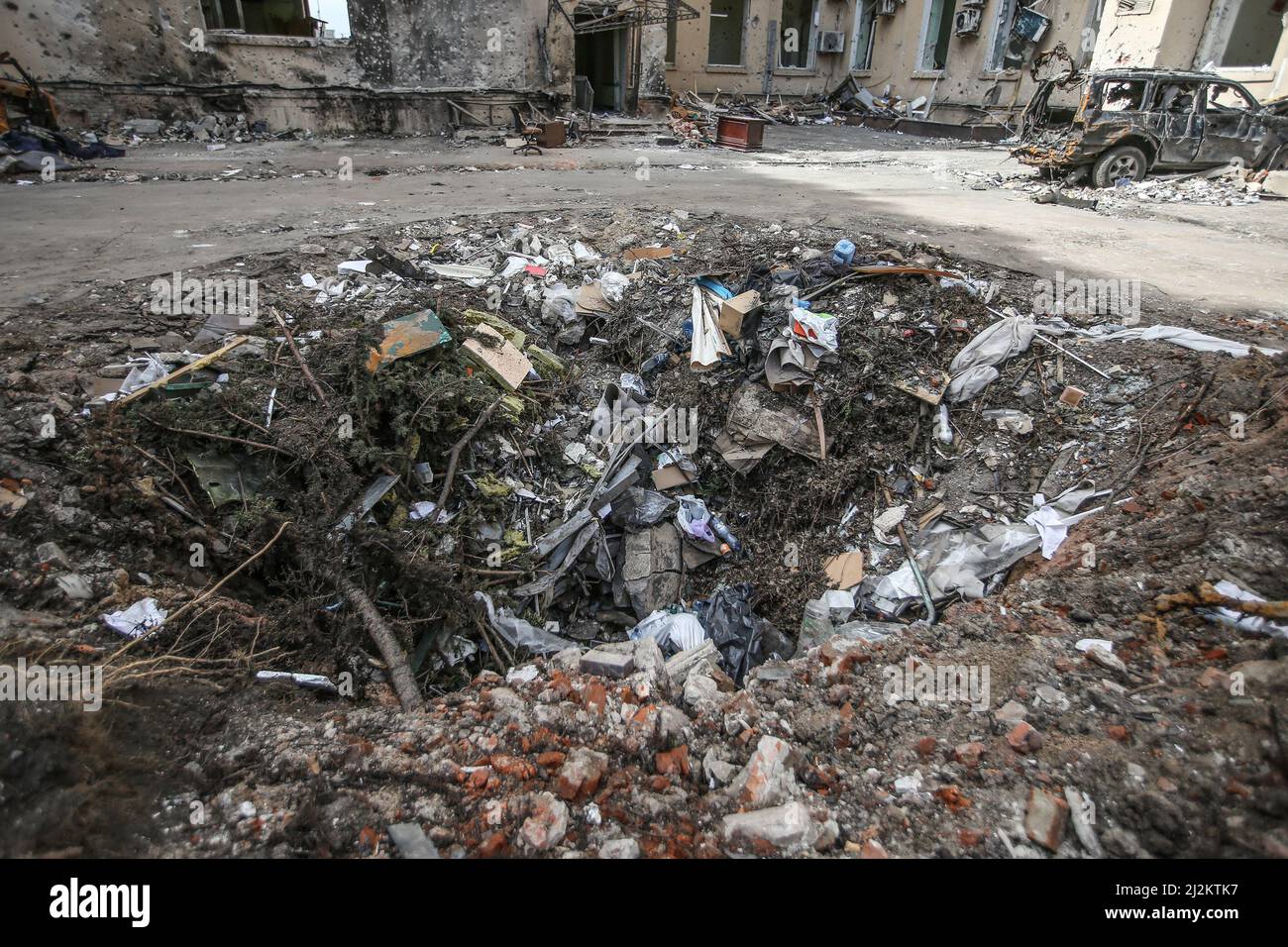 Crater created by a Russian missile attack on April 02, 2022 in Kharkiv, Ukraine. Stock Photo