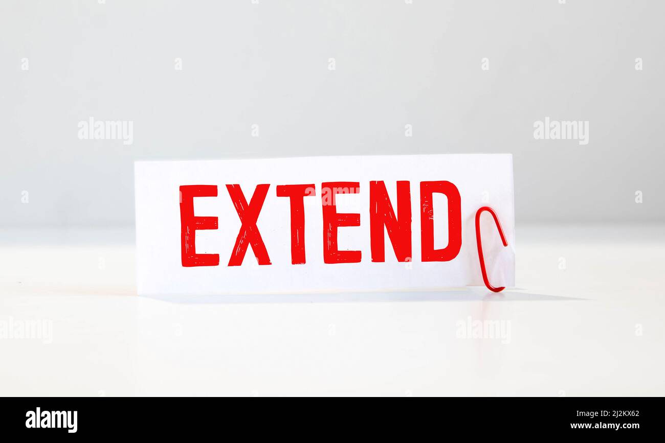 The word EXTENDE is written in the notebook with office tools ...