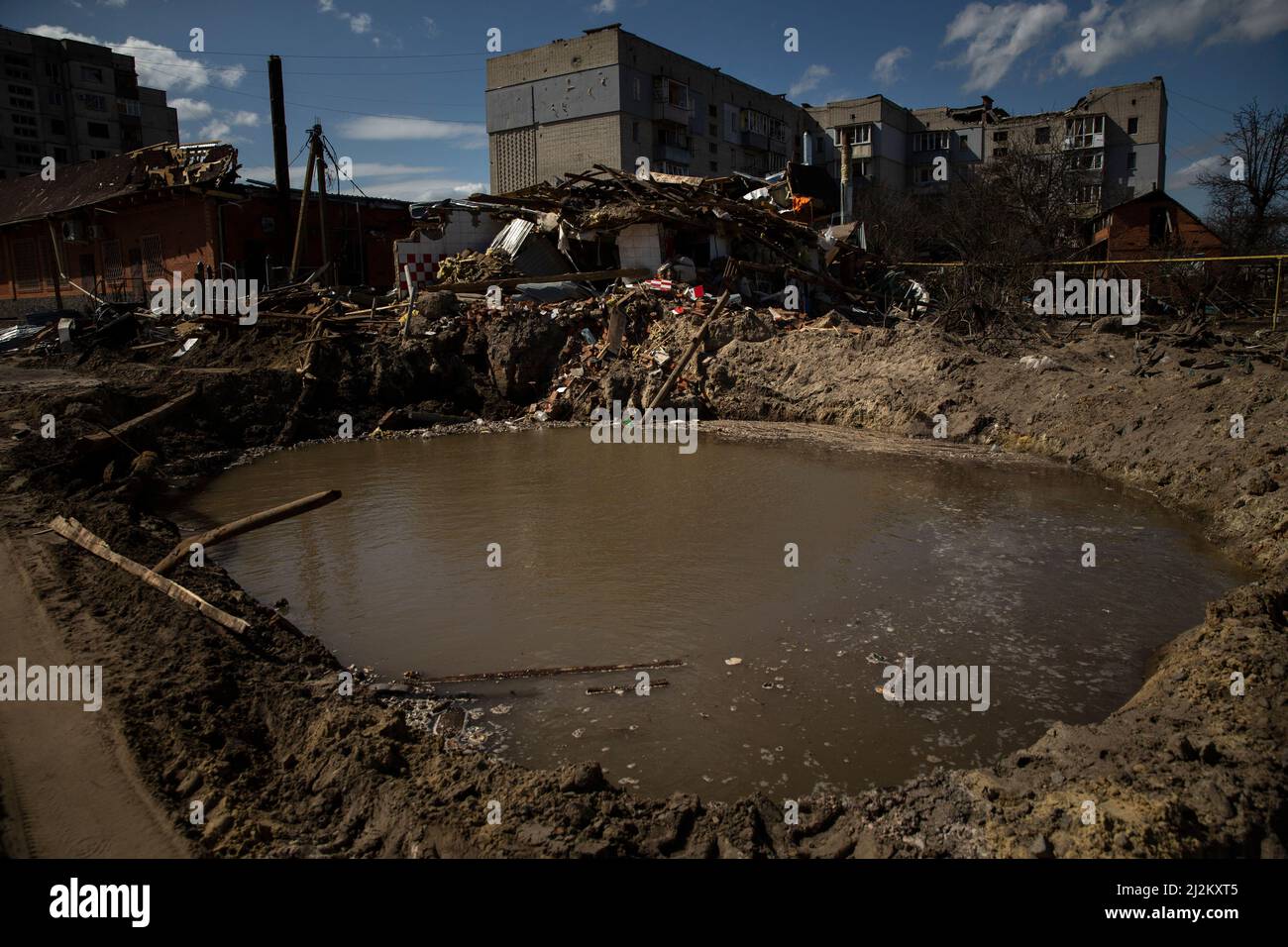 Okhtyrka, Sumy, Ukraine. 2nd Apr, 2022. Water fills a crater created by a Russian bomb at Okhtyrka, Ukraine on April 2, 2022. The area has been heavily damaged by Russian shelling since Russia invaded Ukraine. (Credit Image: © Daniel Carde/ZUMA Press Wire) Credit: ZUMA Press, Inc./Alamy Live News Stock Photo