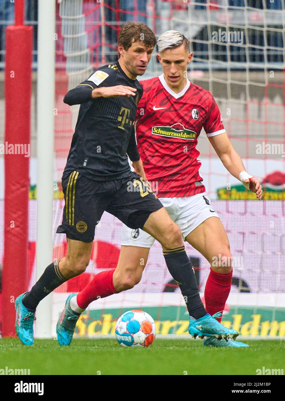Freiburg, Germany. 02nd Apr, 2022. Eric MAXIM CHOUPO-MOTING (FCB 13)  compete for the ball, tackling, duel, header, zweikampf, action, fight against Nico Schlotterbeck, FRG 4  in the match SC FREIBURG - FC BAYERN MÜNCHEN 1-4 1.German Football League on April 2, 2022 in Freiburg, Germany. Season 2021/2022, matchday 28, 1.Bundesliga, FCB, München, 28.Spieltag. FCB, © Peter Schatz / Alamy Live News    - DFL REGULATIONS PROHIBIT ANY USE OF PHOTOGRAPHS as IMAGE SEQUENCES and/or QUASI-VIDEO - Credit: Peter Schatz/Alamy Live News Stock Photo