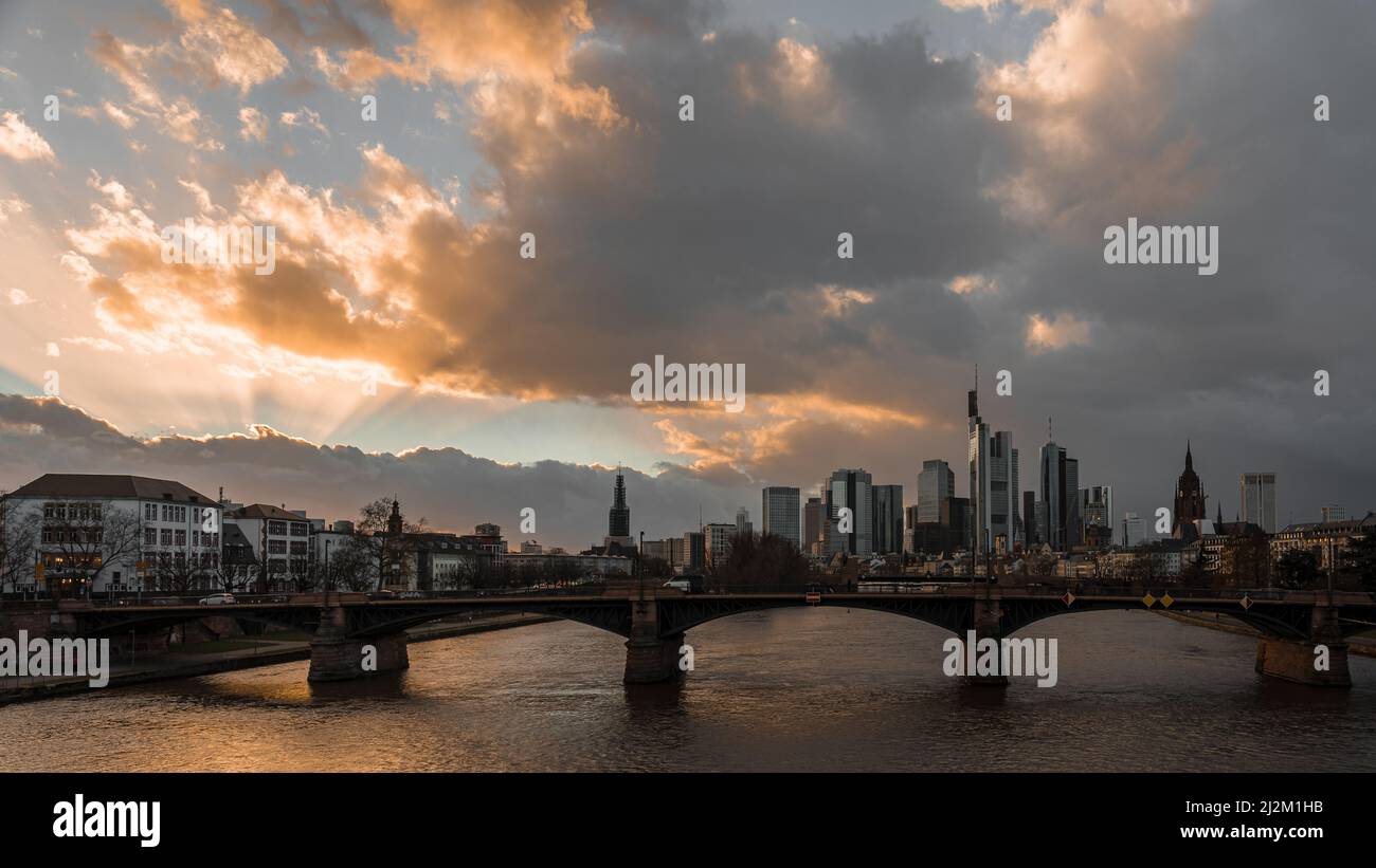A bridge over a river flowing through a city with high-rise buildings ...