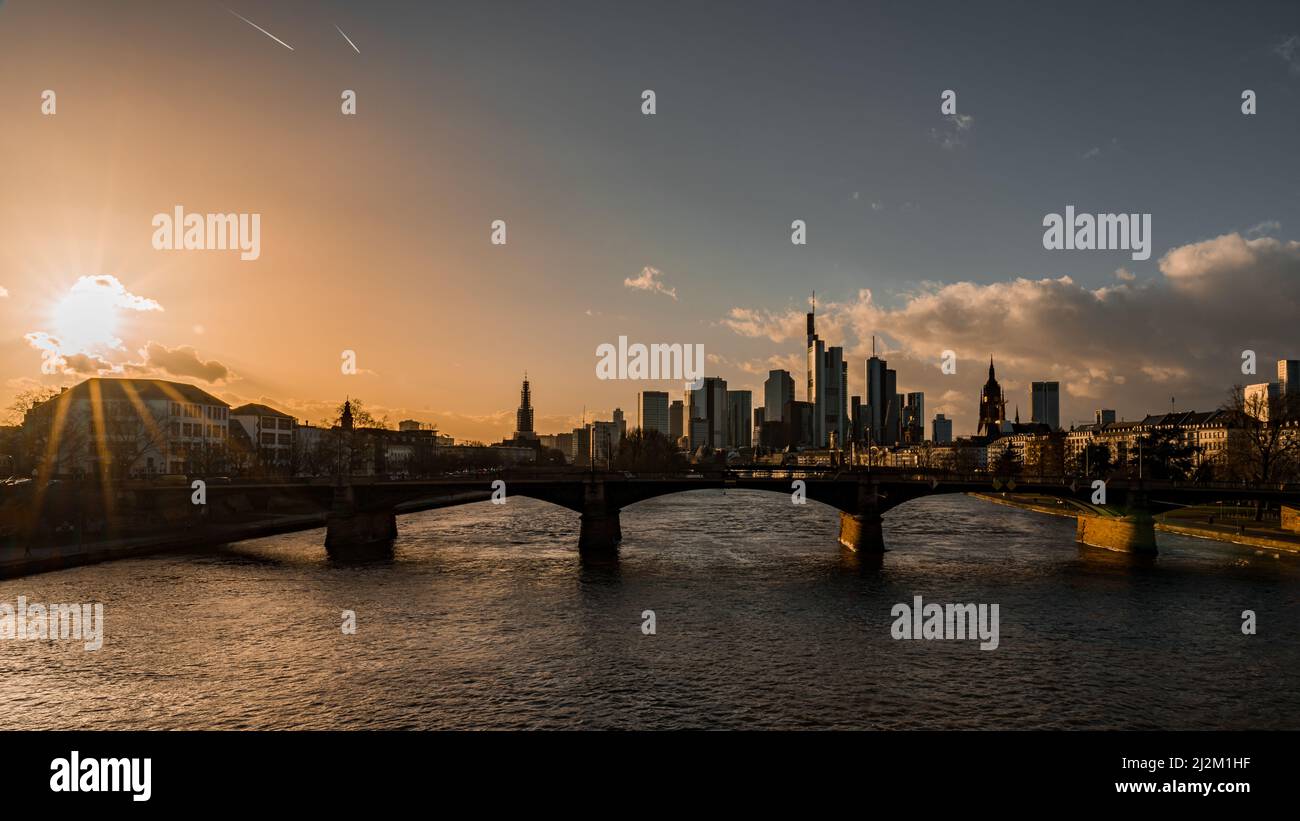 A bridge over a river flowing through a city with high-rise buildings ...
