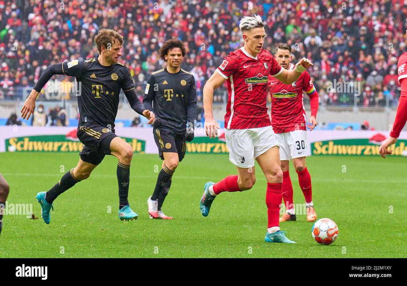 Freiburg, Germany. 02nd Apr, 2022. Nico Schlotterbeck, FRG 4  Christian Günter, FRG 30 compete for the ball, tackling, duel, header, zweikampf, action, fight against Thomas MUELLER, MÜLLER, FCB 25 Leroy SANE, FCB 10  in the match SC FREIBURG - FC BAYERN MÜNCHEN 1-4 1.German Football League on April 2, 2022 in Freiburg, Germany. Season 2021/2022, matchday 28, 1.Bundesliga, FCB, München, 28.Spieltag. FCB, © Peter Schatz / Alamy Live News    - DFL REGULATIONS PROHIBIT ANY USE OF PHOTOGRAPHS as IMAGE SEQUENCES and/or QUASI-VIDEO - Credit: Peter Schatz/Alamy Live News Stock Photo
