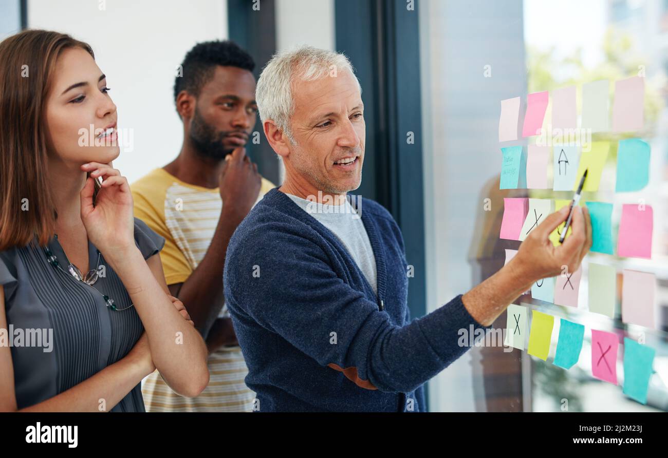 Dont wait for opportunity, create it. Cropped shot of a group of businesspeople having a brainstorming session. Stock Photo