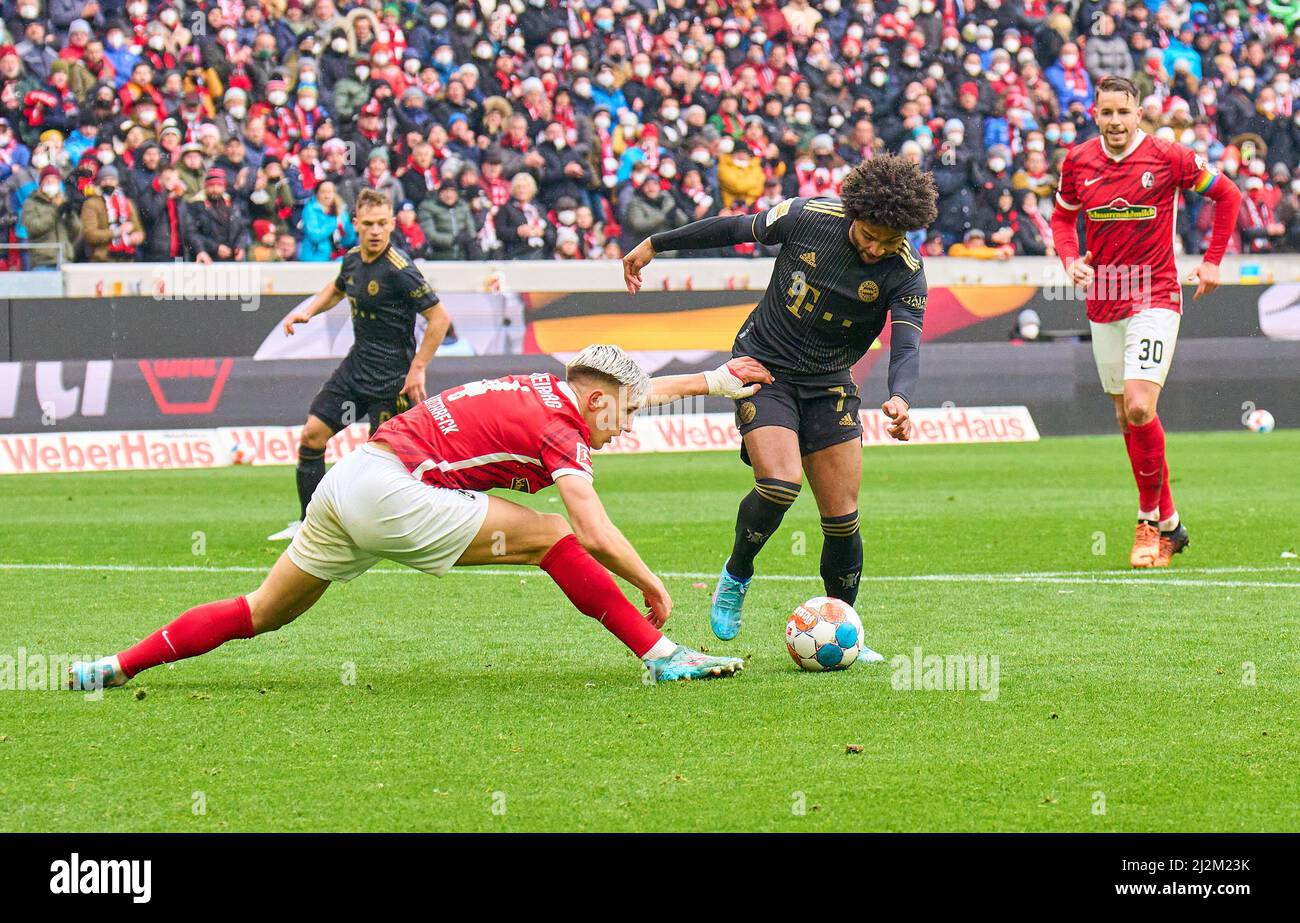 Freiburg, Germany. 02nd Apr, 2022. Serge GNABRY, FCB 7   scores, shoots goal , Tor, Treffer, Torschuss, 1-2 against Nico Schlotterbeck, FRG 4  in the match SC FREIBURG - FC BAYERN MÜNCHEN 1-4 1.German Football League on April 2, 2022 in Freiburg, Germany. Season 2021/2022, matchday 28, 1.Bundesliga, FCB, München, 28.Spieltag. FCB, © Peter Schatz / Alamy Live News    - DFL REGULATIONS PROHIBIT ANY USE OF PHOTOGRAPHS as IMAGE SEQUENCES and/or QUASI-VIDEO - Credit: Peter Schatz/Alamy Live News Stock Photo
