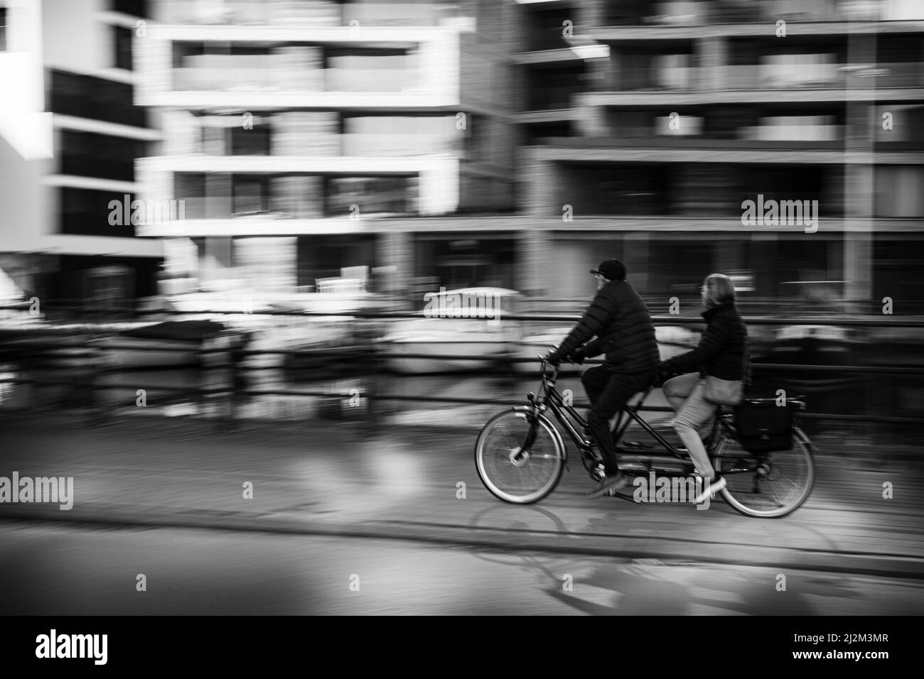 Couple riding on a tandem duo bike Stock Photo