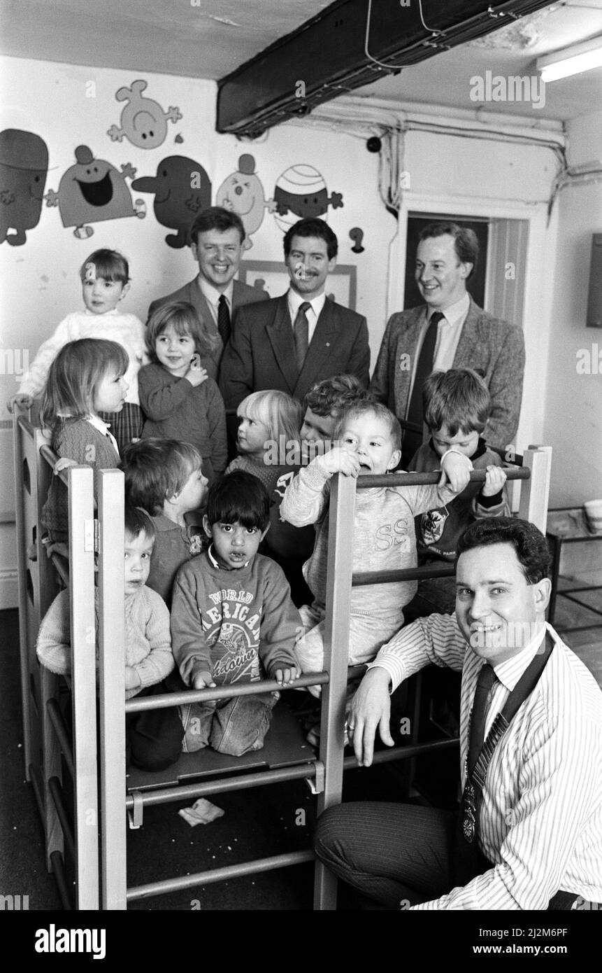 Climbing high... youngsters at Knowl Bank Playschool, Golcar, try out their new climbing frame donated by Colne Valley Round Table. The members decided to buy the indoor frame after they received a request for help from the playschool organisers. Seen presenting it is chairman Mr Martin Matthews (front) watched by community services chairman Mr Graham Banks and members Mr John Collett and Mr Nicholas Selby. 11th April 1989. Stock Photo