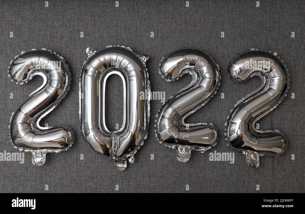 new year 2022 shiny silver balloons on grey background Stock Photo