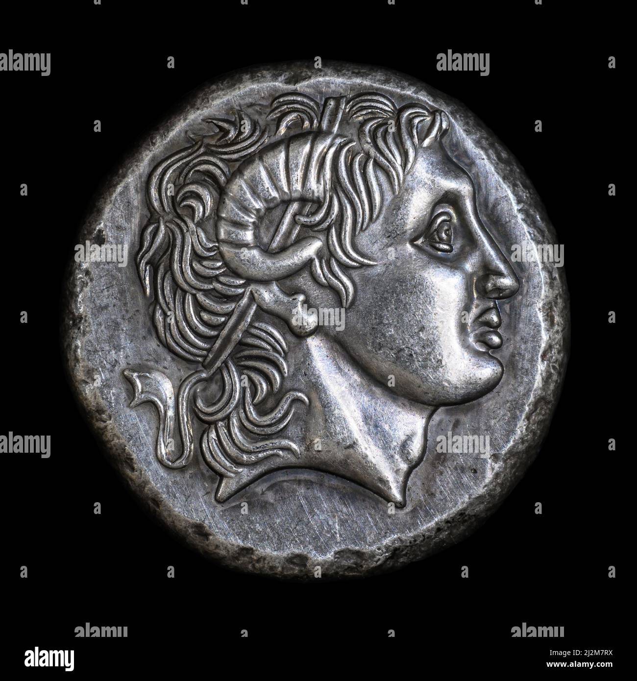 Alexander the Great head on Ancient Greek coin of Lysimachus, 290 BC. Silver tetradrachm, old rare money isolated on black, macro. Concept of Hellenis Stock Photo