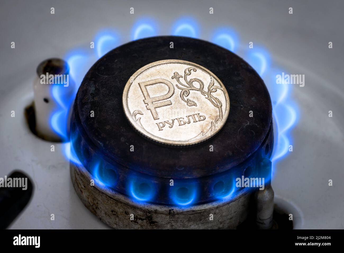Gas burner and ruble coin, Russian money on home gas stove. Natural propane gas flame and ruble currency. Concept of Russia and Europe economy, gas co Stock Photo
