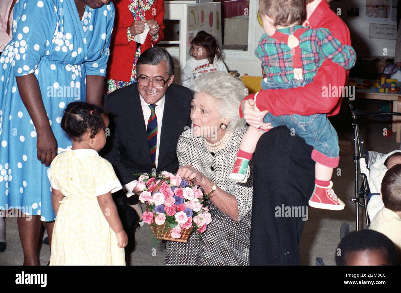 Mrs Barbara Bush, wife of the President of the USA, visits the Strand Adult Education Centre in Brixton. She saw several classes and spoke to staff and students. Pictured, Barbara Bush in the creche, beside her is Kenneth Baker, Secretary of State for Education and Science. 1st June 1989. Stock Photo