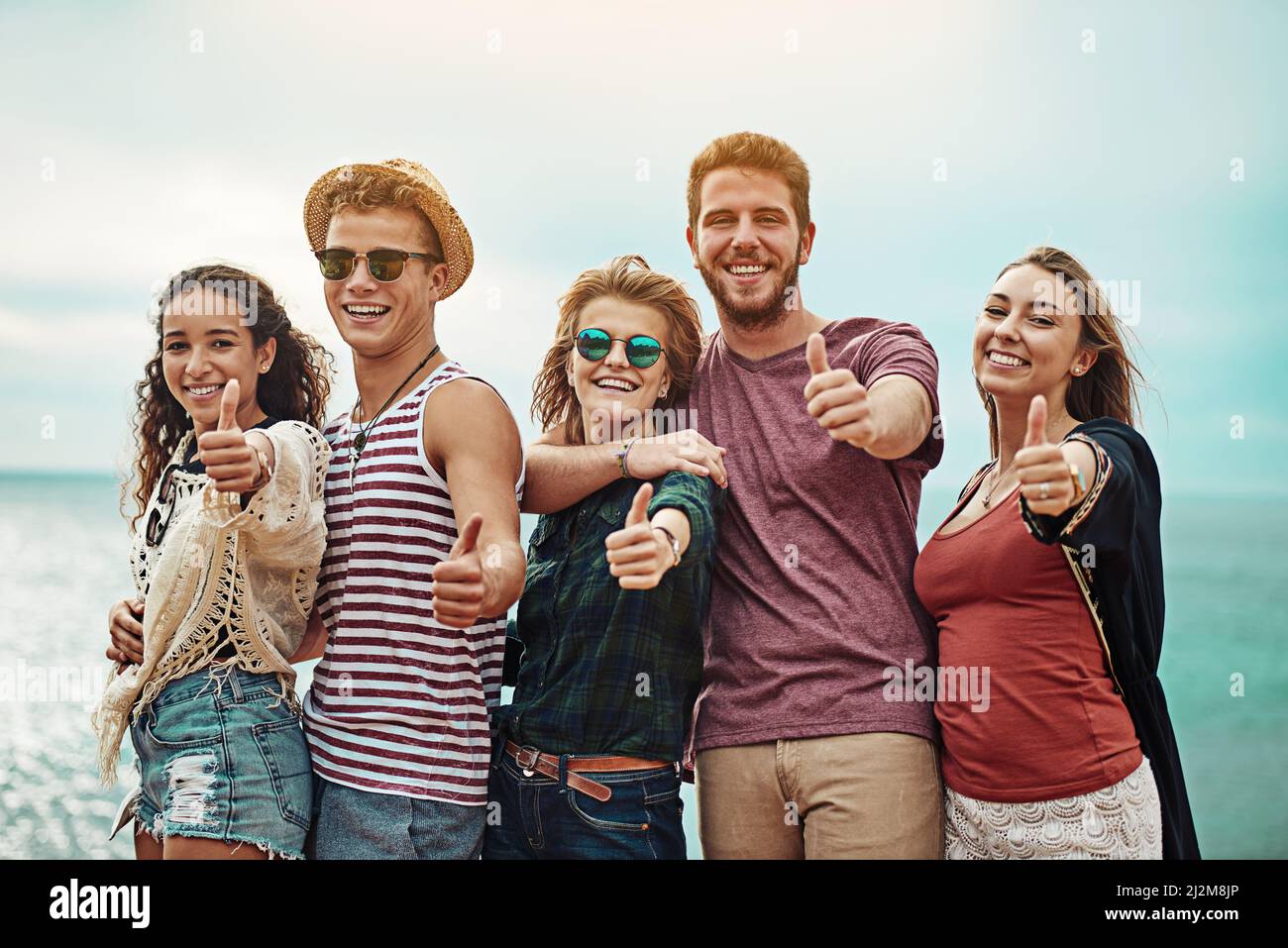 Thumbs up to lifelong friends. Portrait of a group of friends showing ...