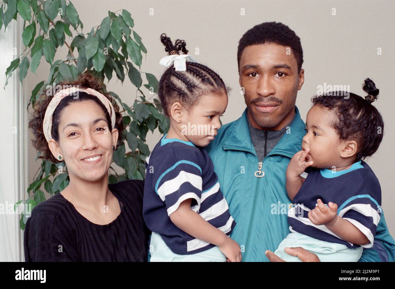 Michael Watson, MBE is a British former professional boxer who competed from 1984 to 1991. He held the Commonwealth middleweight title from 1989 to 1991, and challenged three times for a world title between 1990 and 1991.(Picture) Michael Watson with wife  Zara and kids Jamilla, 2., and Lala, 1. 24th April 1989 Stock Photo